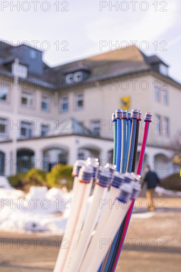 Colourful bundles of cables in front of a building and snow-covered ground, fibreglass