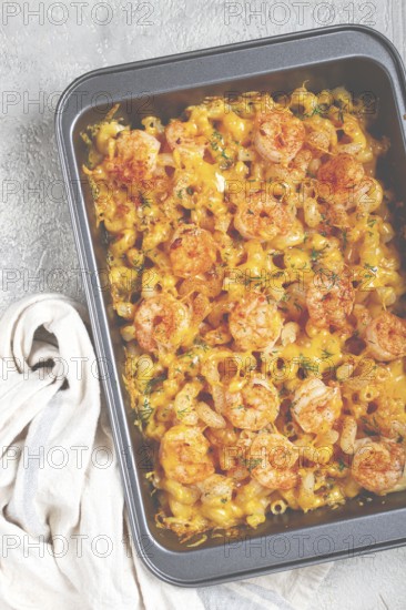 Pasta with shrimp and cheese, with a golden crust, cooked in a baking dish, homemade, no people