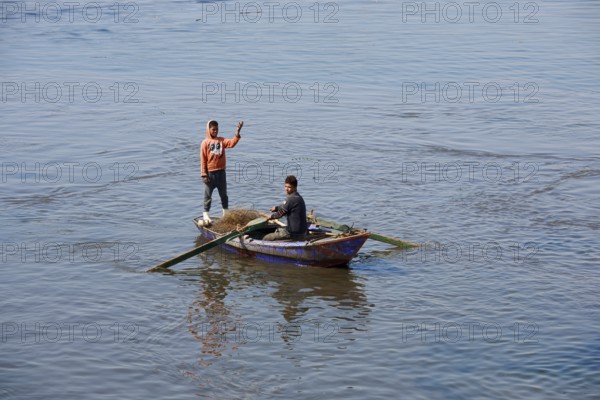 Boys in a rowboat fishing on the Nile, Luxor, Egypt