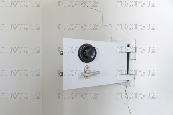 Open white wall safe (Cista valida) with dial regulator in a bright room