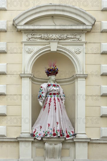 Mannequin wearing Ukrainian traditional costume in a niche of a house, Czernowicz, Ukraine