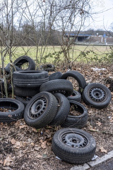 Illegally disposed of car tires and other trash, on a side street in Duisburg-Kaiserberg, North