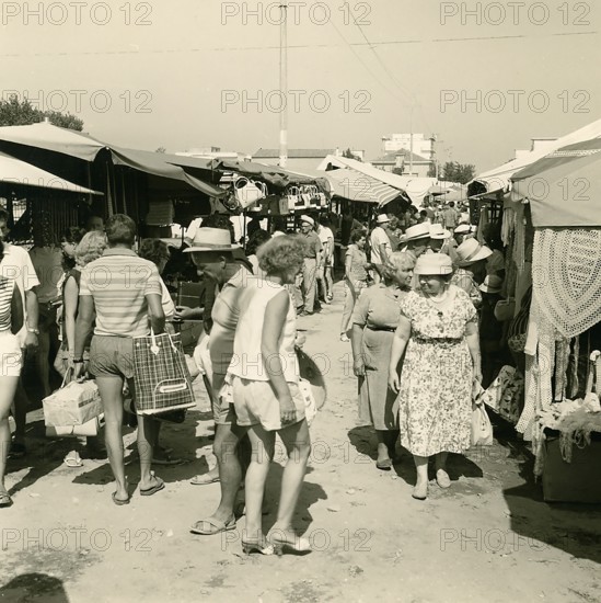Historical photo summer 1961, market with tourists, Rimini, Italy