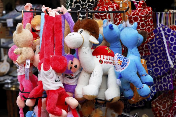 Sales stand with stuffed animals and other souvenirs for tourists at a market in Marrakech,