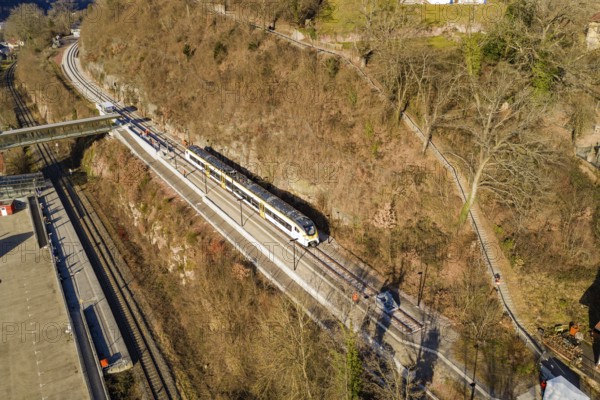 A train travels along a route near the forest, crosses a bridge, test run on the new Hermann-Hesse