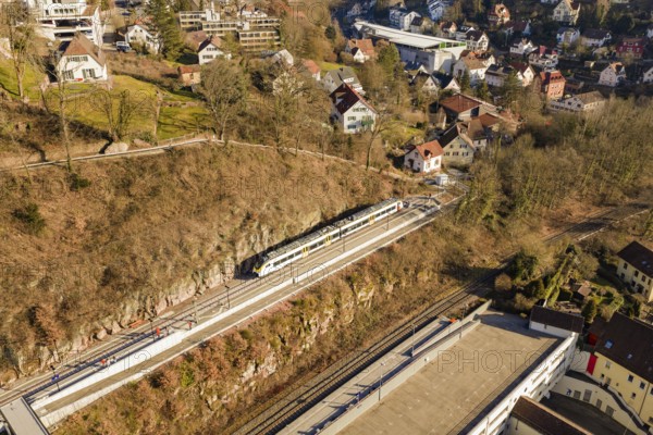 Overview of a train in a village with numerous houses and autumn landscape, test run on the new
