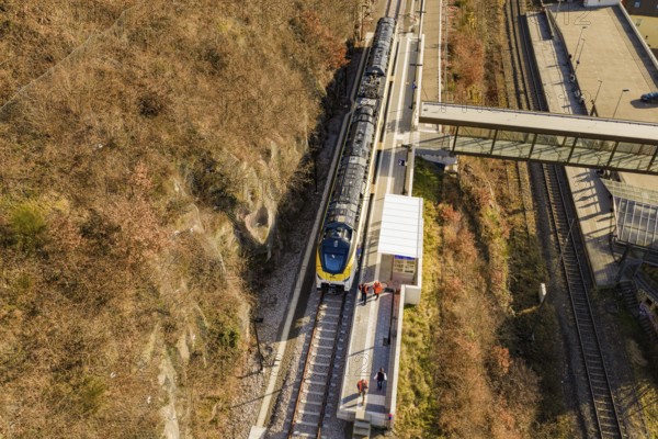 Aerial view of a train on railroad tracks with autumn landscape in the background, test run on the