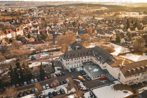 A part of a city with buildings, open parking areas and snow to see, District Office, Freudenstadt,