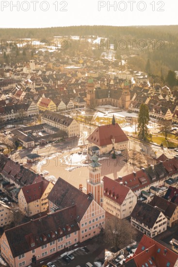 Traditional old town with church and market square, taken from the air in winter light,