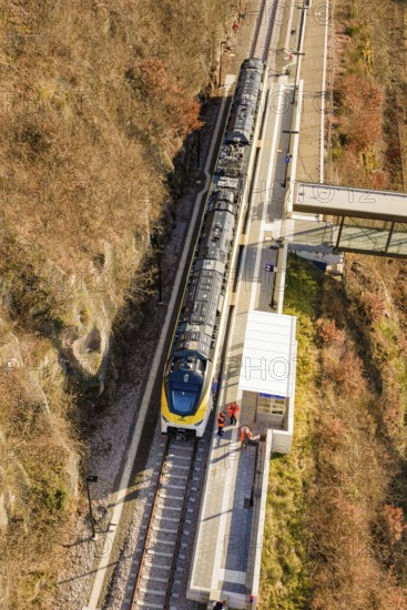 Bird's eye view of a train at a station in an autumn landscape, test trip on the new Hermann-Hesse