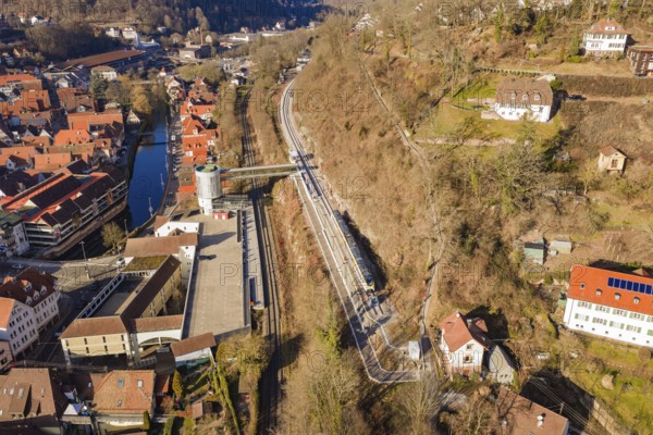 City panorama with train lines along a hill that run through an urban environment, test run on the