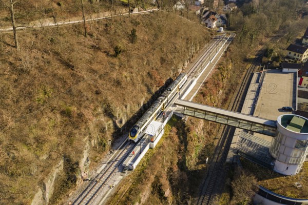 Overview of train journey through hilly vegetation and bridge in urban surroundings, test run on