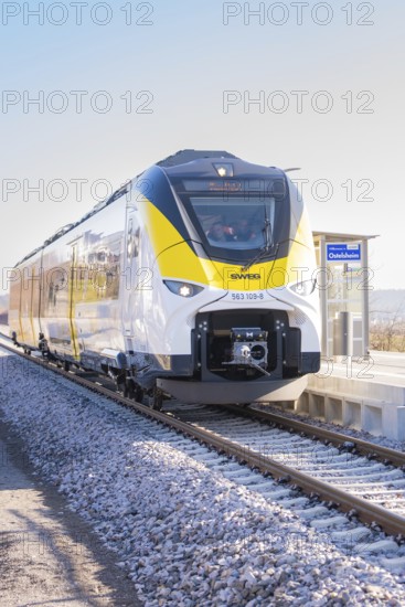 Modern yellow-black train on a sunny platform, test run on the new Hermann-Hesse railway with