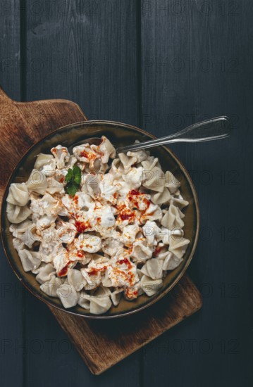 The dish features a generous serving of Turkish dumplings topped with velvety yogurt and a drizzle