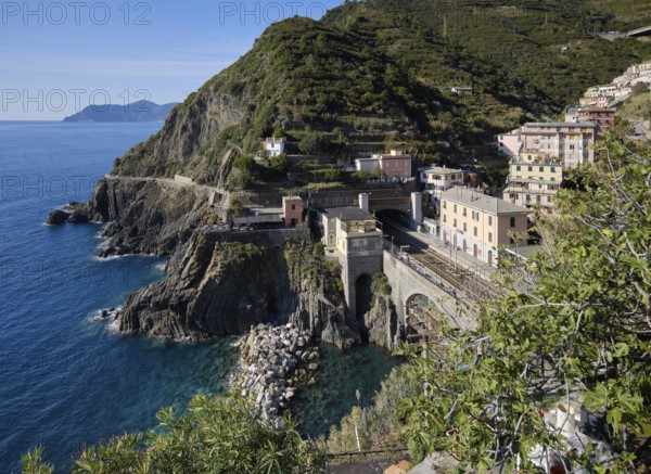Coastal landscape with houses and view of the train station in the fishing village of Riomaggiore,