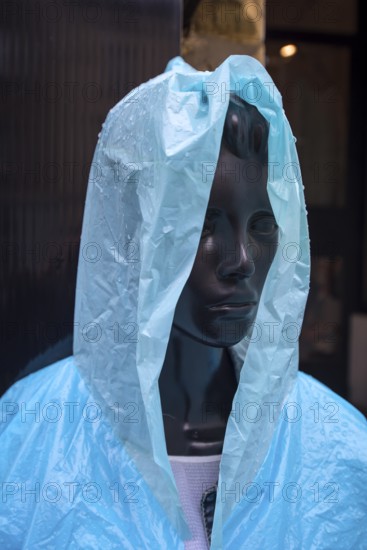 Window mannequin with rain cape in rain, Krakow, Poland