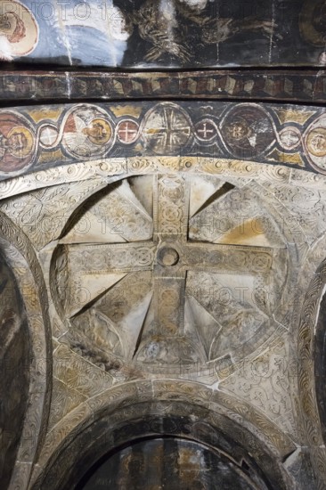 Cross-shaped frescoes on a richly decorated church ceiling in black and white tones, Nikorzminda