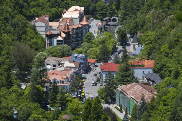 Overview of the city nestled in a green, wooded area with various buildings, Borjomi, Borjomi