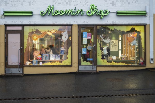 Illuminated shop window, shop in the city center selling merchandise and products related to the
