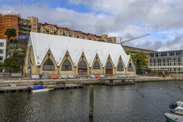 Large historic market hall in Gothenburg with pointed roof on the water, Gothenburg, Västra