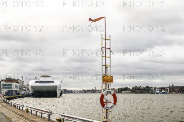 Stena Line fast ferry catamartan in port on a cloudy day with lifebuoy in the foreground, Stena