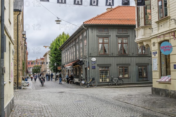 Charming old town with cobblestones and historic buildings, people walking on the street in