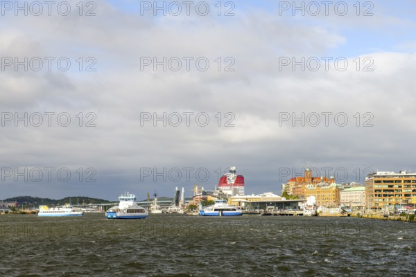 View of Gothenburg harbour with boats and municipal buildings under cloudy sky, Gothenburg, Västra
