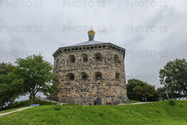 Massive historic stone fortress Skansen Kronan with a decorative crown on a hill surrounded by