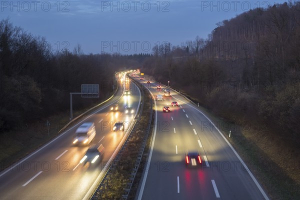 Night view of a motorway trip in the dark, surrounded by forest and vehicle lights, near Stuttgart,