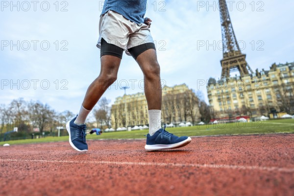 Athlete running on a red track with the iconic eiffel tower and parisian buildings in the