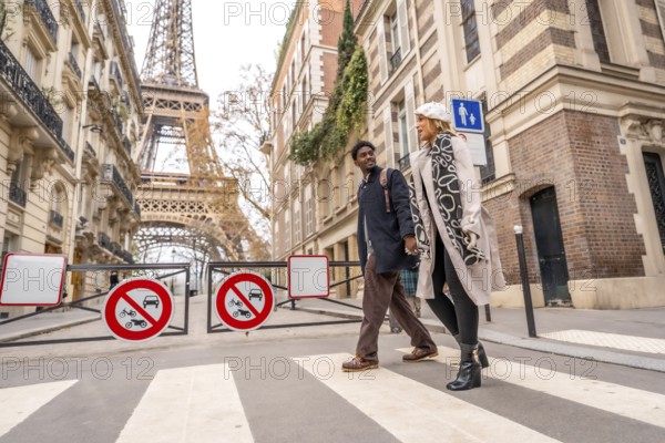Loving couple enjoying a romantic leisure walk in a charming parisian neighborhood, crossing a