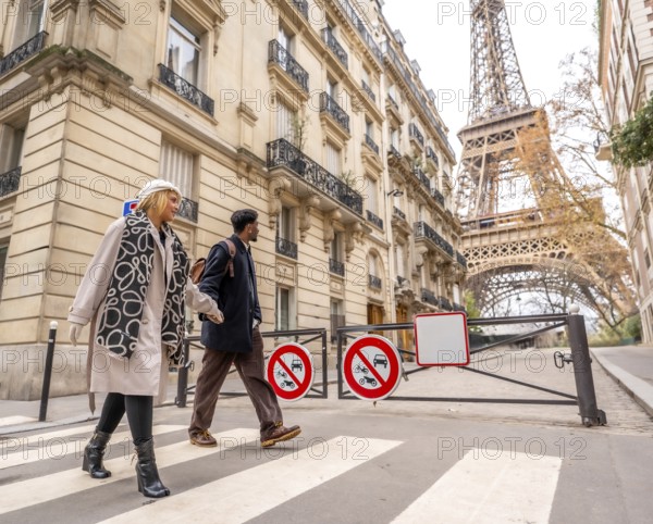 Diverse couple crossing a pedestrian street in paris, enjoying a city trip together with classical