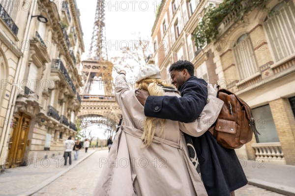 Young diverse couple embracing and enjoying a romantic trip in the streets of paris, walking