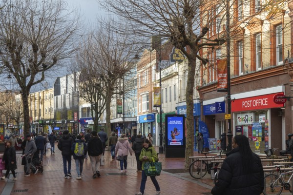 Shoppers in pedestrianised Broad Street on winter day, town centre of Reading, Berkshire, England,
