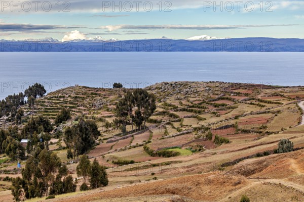 Landscape with a wide view over fields, a lake and a cloudy sky on the horizon, The countryside and
