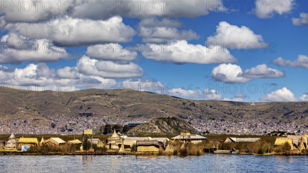 Village with traditional lakeside buildings surrounded by hills and clouds, The floating reed