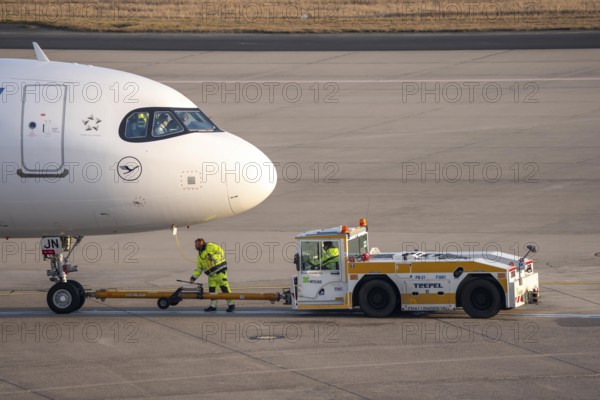 Lufthansa City Airbus A320neo is pushed from the gate onto the taxiway, ready to go, to