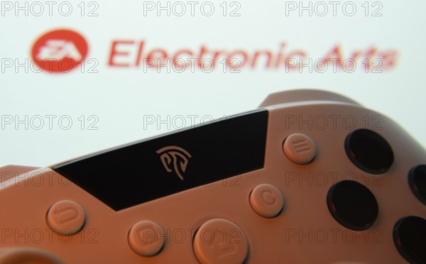 Dhaka, Bangladesh- 24 Mar 2025: A close-up of a gamepad with the Electronic Arts seen on screen in