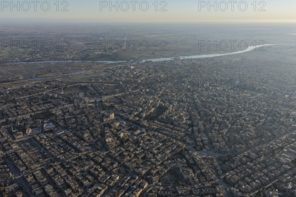 In Deir ez-Zor, Eastern Syria on January 21, 2026, an aerial drone shot captures the city landscape