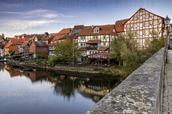 Half-timbered houses on a river with beer garden and bridge in an autumn atmosphere, The town of