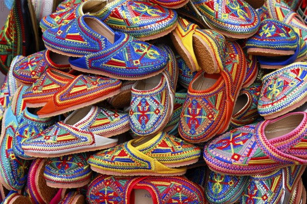 Sales stand with traditional colorful slippers at a market in Marrakech, historic old town, Medina,