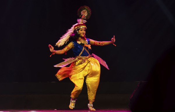 An artist perform classical Manipuri Ras Leela during a cultural evening program at Shilpgram