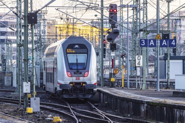 InterCity IC to Zurich leaving Stuttgart Central Station in the morning. Rail signals and overhead