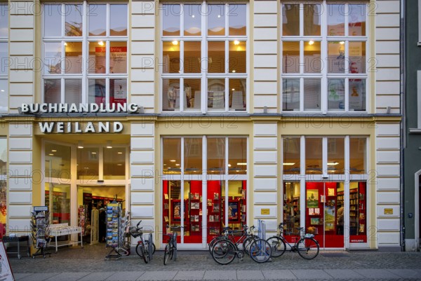 Weiland bookstore with bicycles parked in front of it, at the fish market in the Hanseatic City of