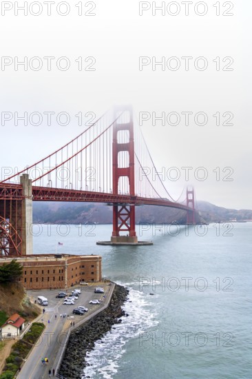 1937 Golden Gate Bridge in the mist, red Art Deco suspension bridge linking San Francisco to Marin