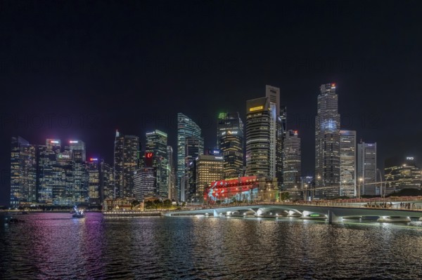 Skyline of the Central Business District, CBD with illuminated skyscrapers and Jubilee Bridge in