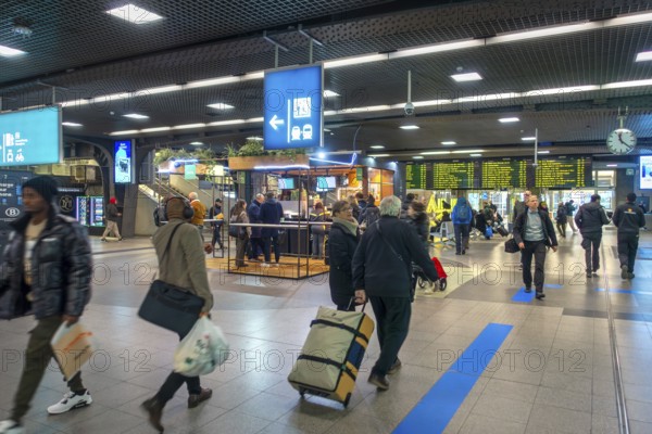 Travelers, commuters, tourists in the main hall of the NMBS Brussels-South railway station, Gare de