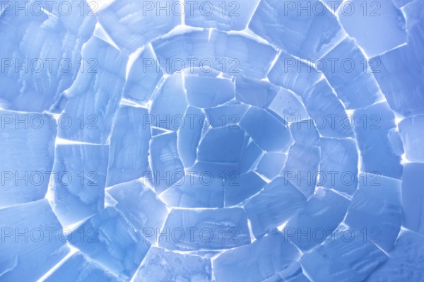 Interior of igloo showing roof built from stacked snow bricks in a catenary, curved shape