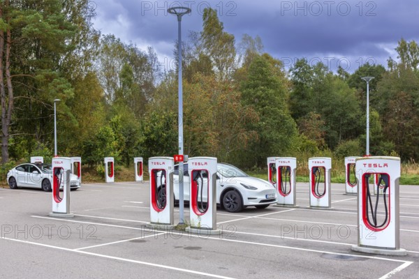 Parking area with public charging station / loading points from Tesla, network of rapid chargers