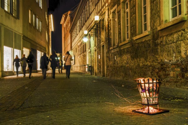 Firebaskets and passers-by set the scene during the long shopping night in the city center of